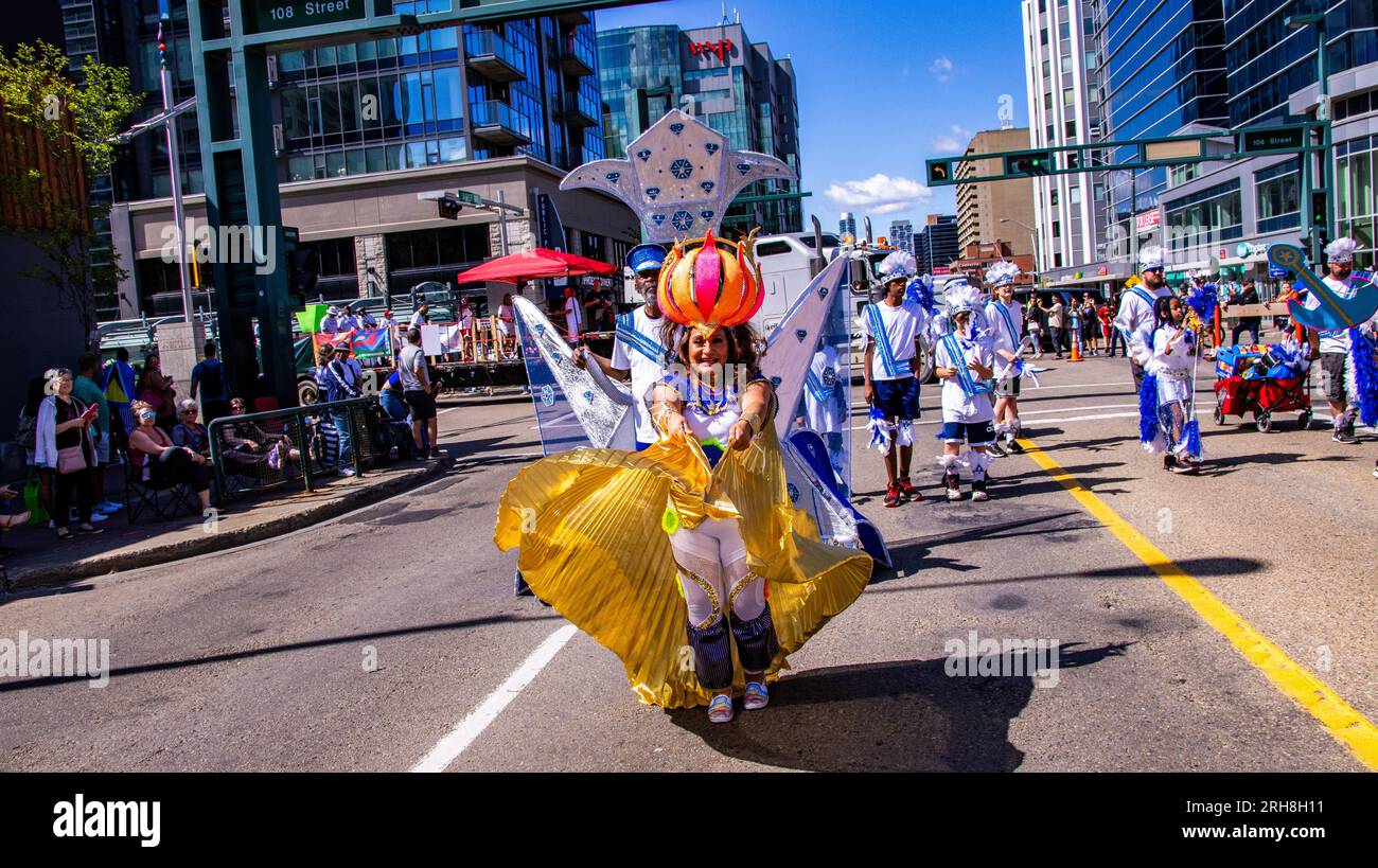 Edmonton, Canada. 13th Aug, 2023. A participant carries a ball on her head. The ball on this participants head is supported by a large spring and moves around as she waves the wings of her costume. The Cariwest festival celebrates the heritage and culture of the islands of the Caribbean. Credit: SOPA Images Limited/Alamy Live News Stock Photo