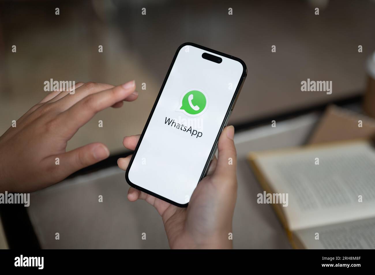 Chiang Mai, Thailand - Aug 14 2023: A female using WhatsApp on her iPhone14. close-up image of a WhatsApp logo on iPhone14's screen. Stock Photo