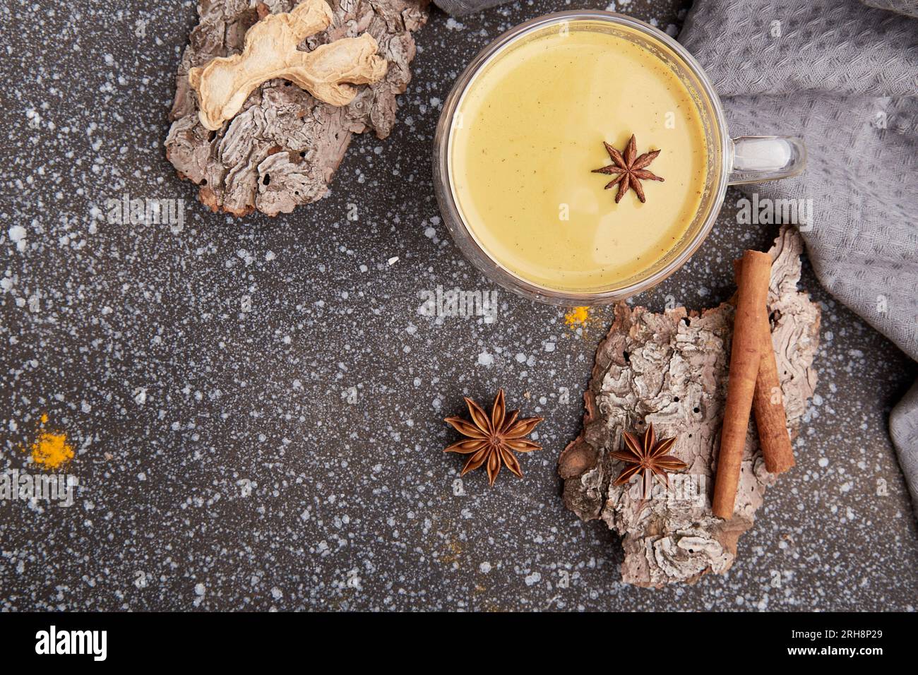 Organic masala tea with star anise, cinnamon, turmeric spices on tree bark. Healthy traditional drink, copy space. Stock Photo