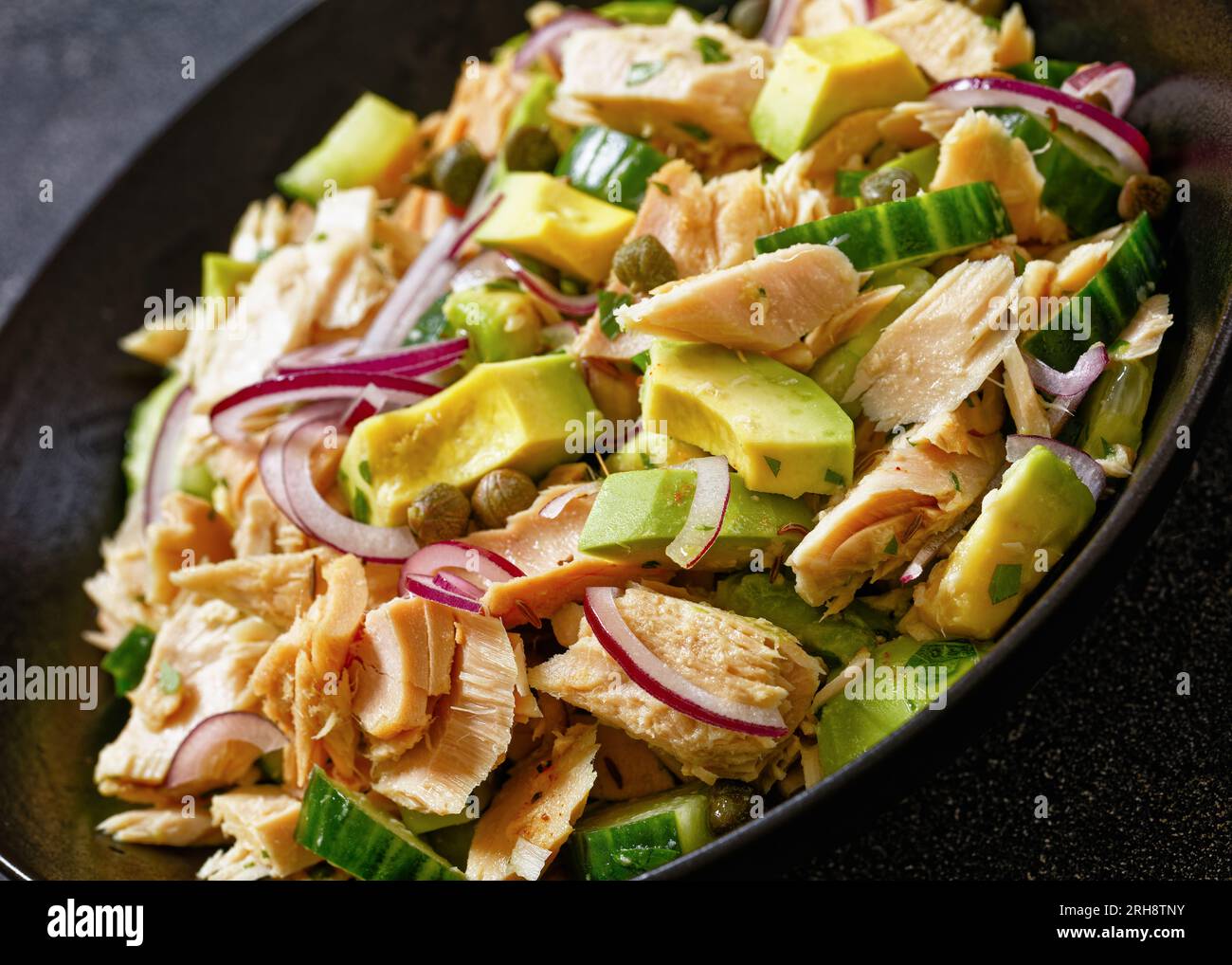 tuna salad with avocado, red onion, cucumber and capers with olive oil