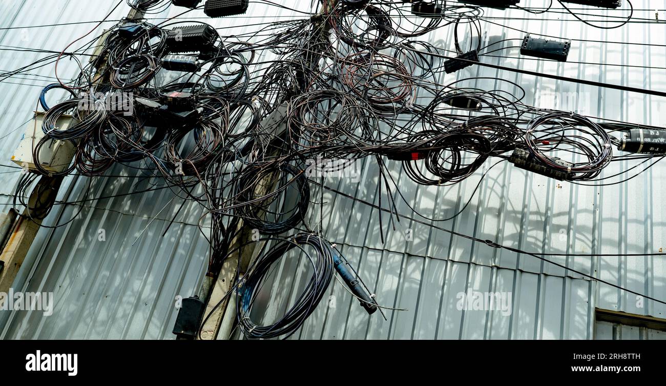 Tangled electrical wires and tangled communication lines on urban