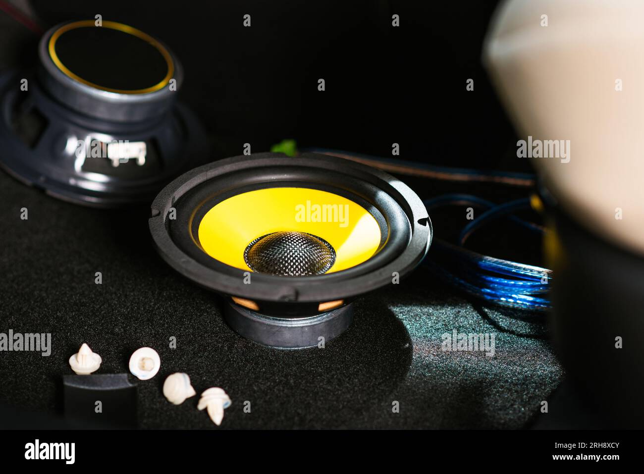 The black audio loudspeaker with yellow diaphragm. Car audio installation concept. Stock Photo