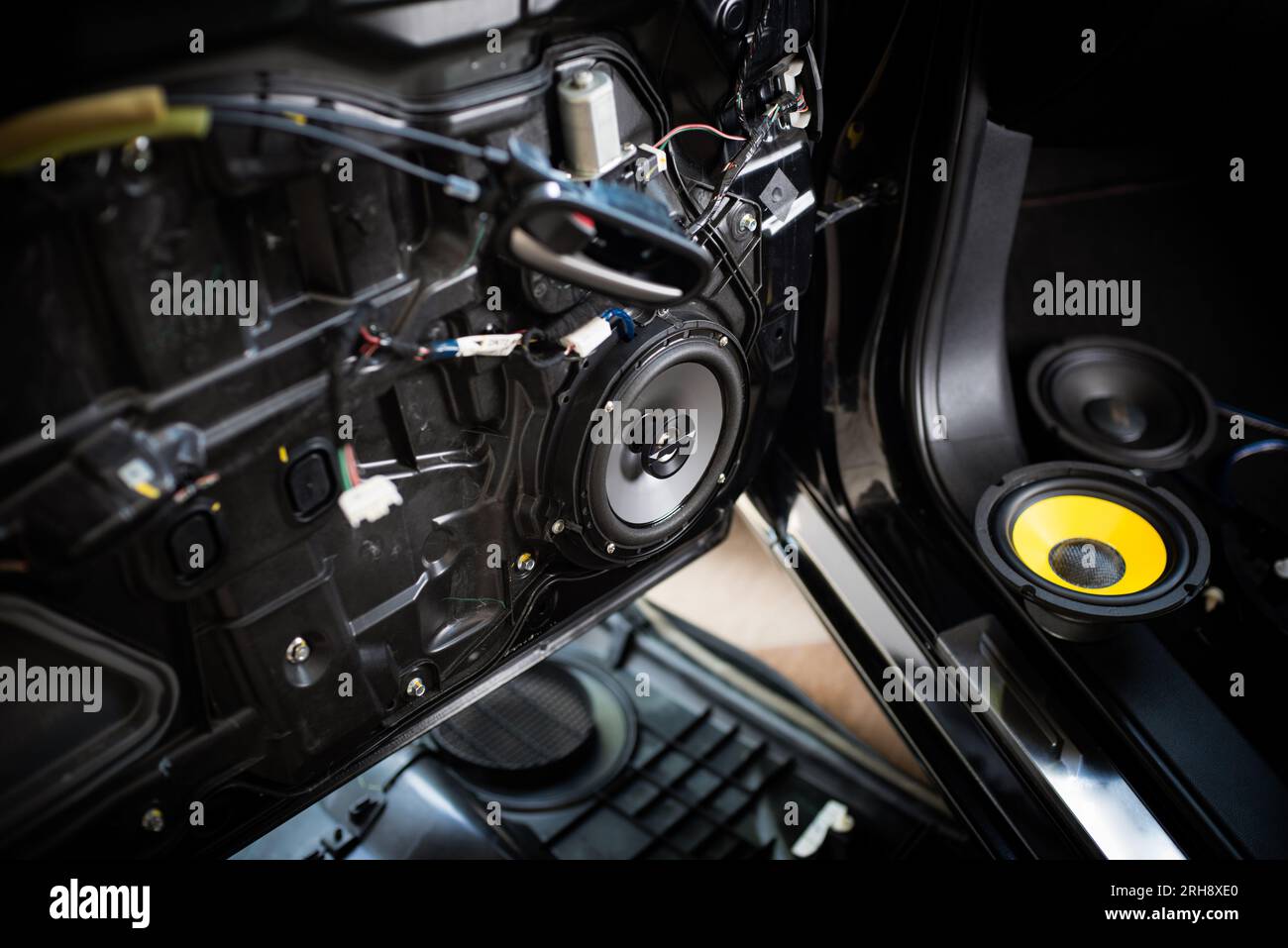 Close up the speaker on the car door during installation. Car audio installation concept. Stock Photo
