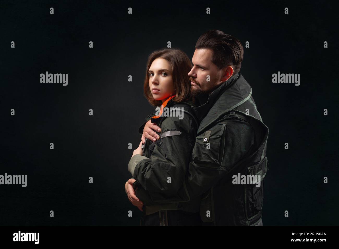Hugging couple on a black background. Support concept. Stock Photo