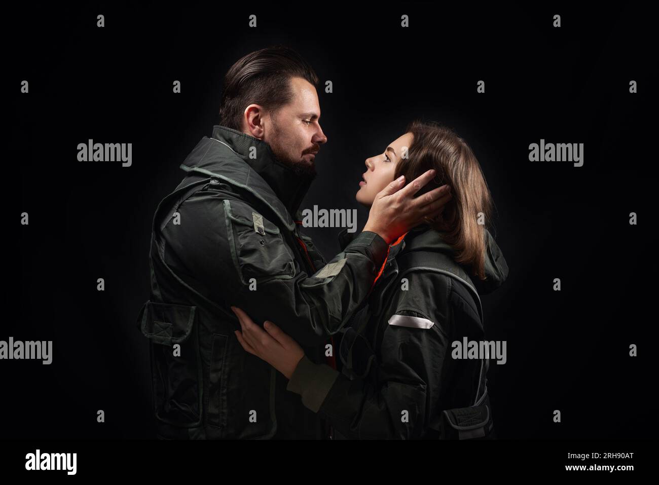 Hugging couple on a black background. Support concept. Stock Photo