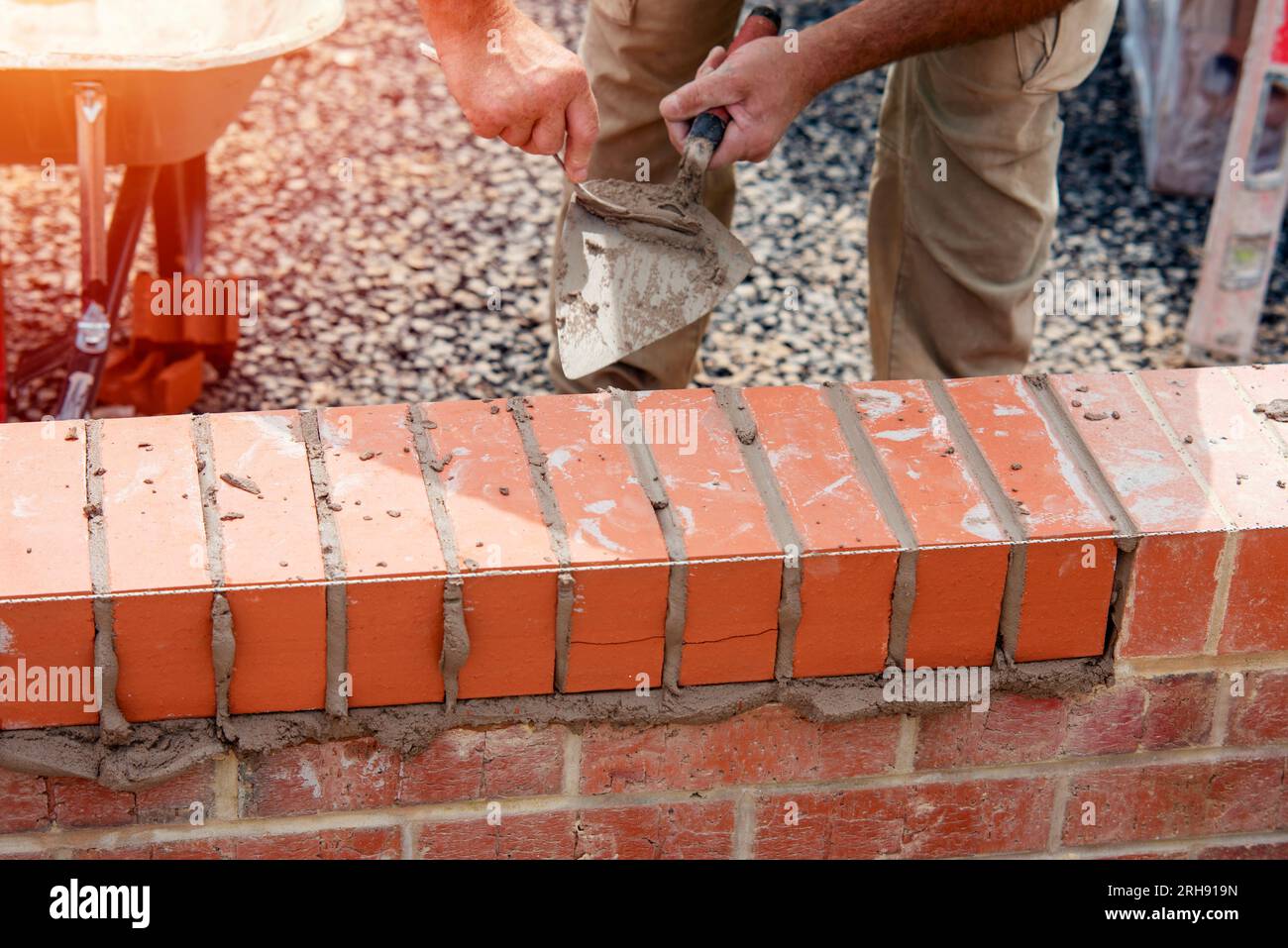 Close up of a brick wall and jointer trowel used by the worker to apply