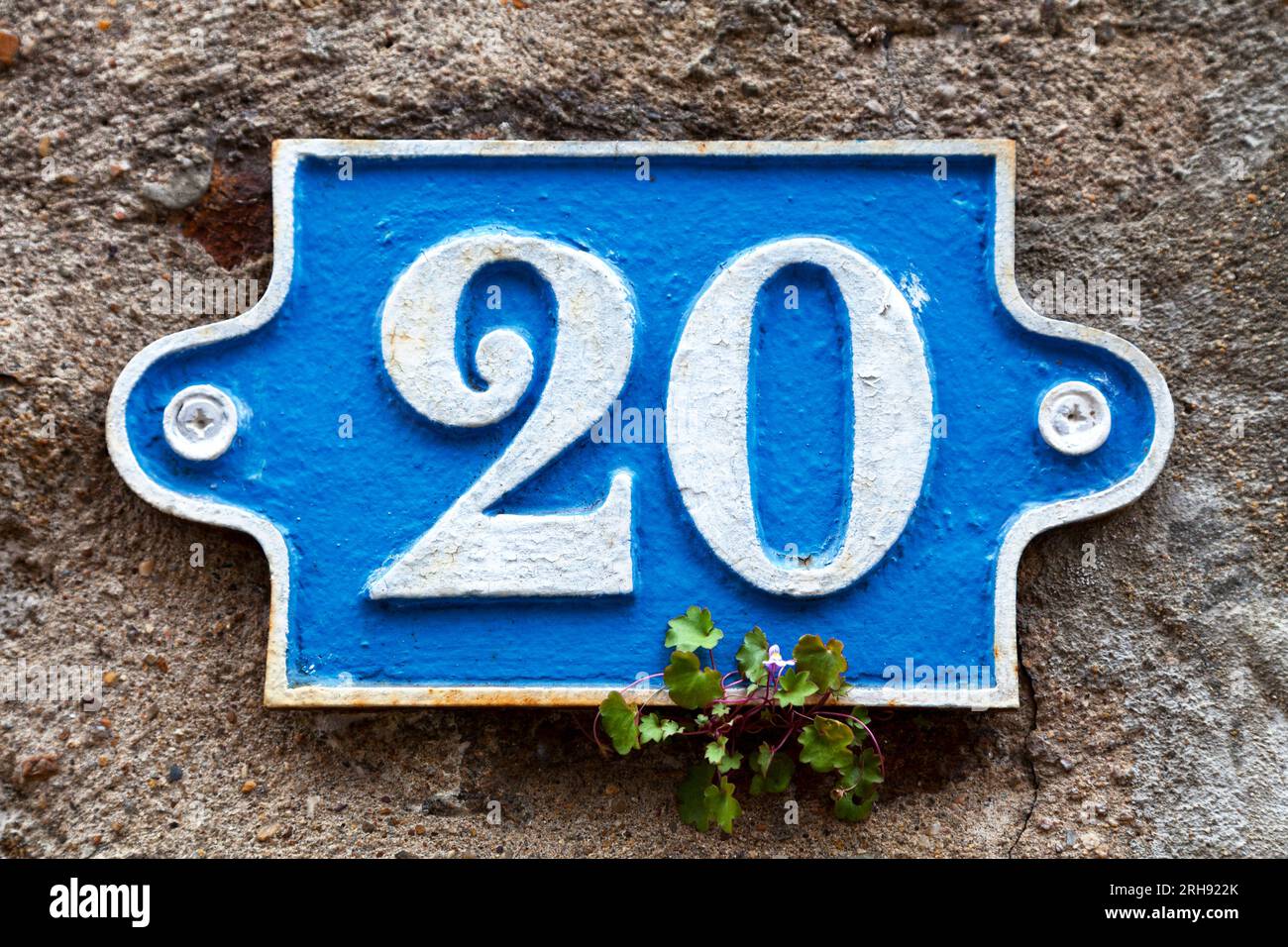 Blue street number plate 22 screwed on a concrete wall Stock Photo Alamy