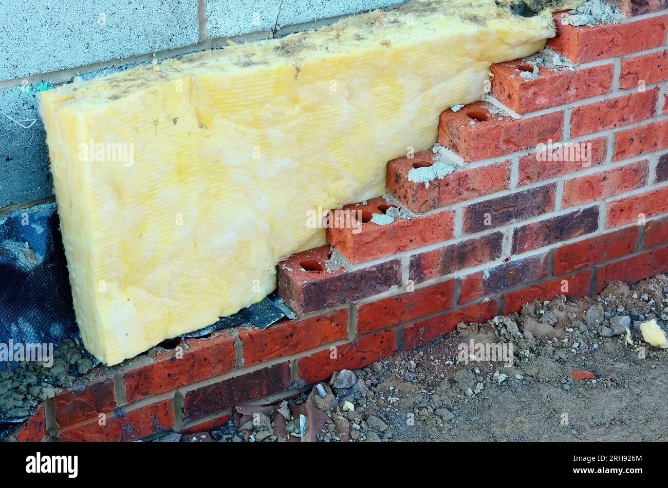 Insulating walls of new build houses by placing rock wool inside wall