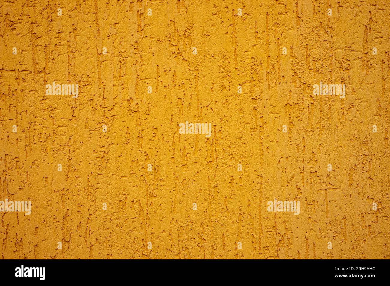 Background of yellow stone wall with drips. Stock Photo