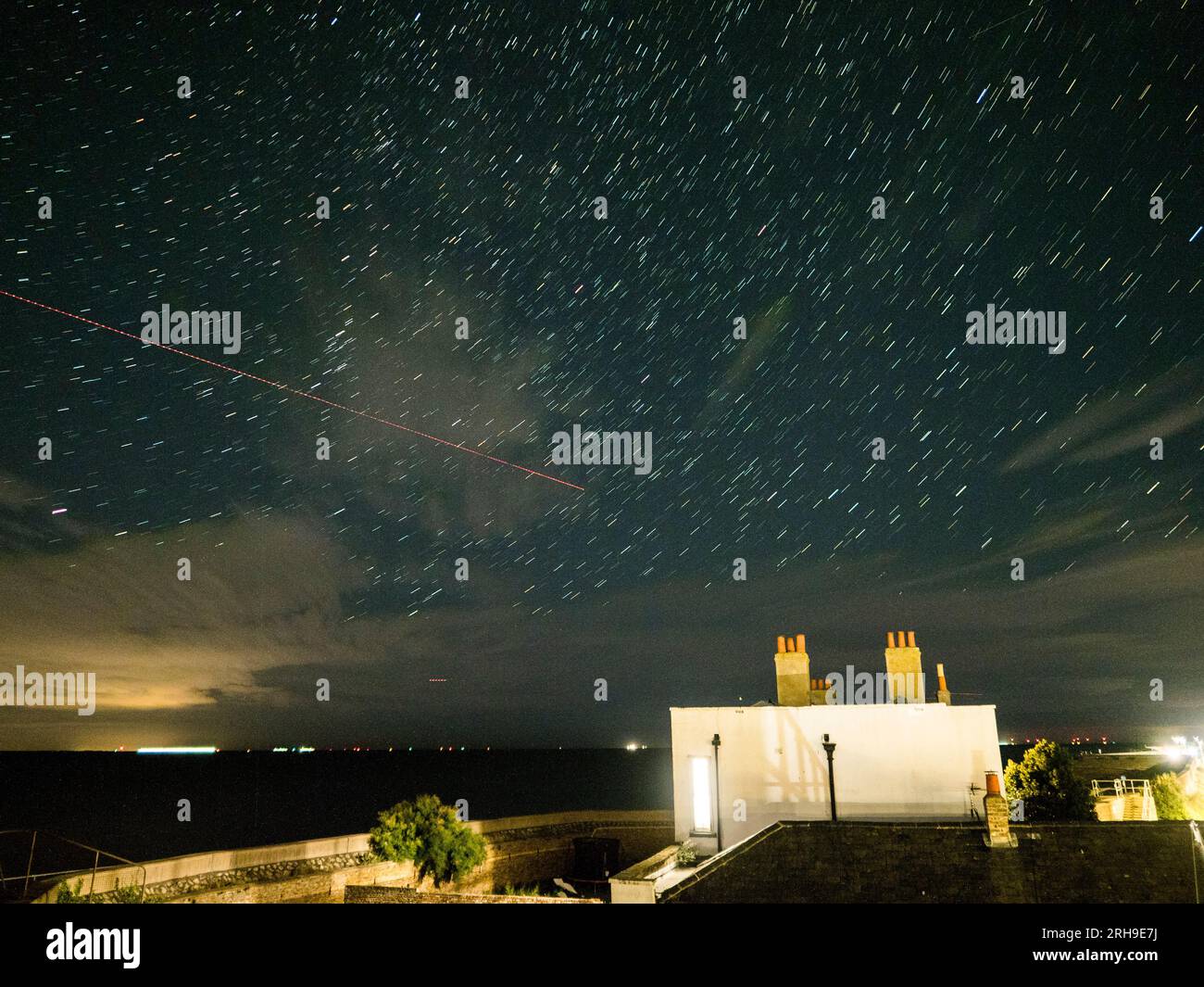 Sheerness, Kent, UK. 14th Aug, 2023. UK Weather plane and star trails in the night sky above