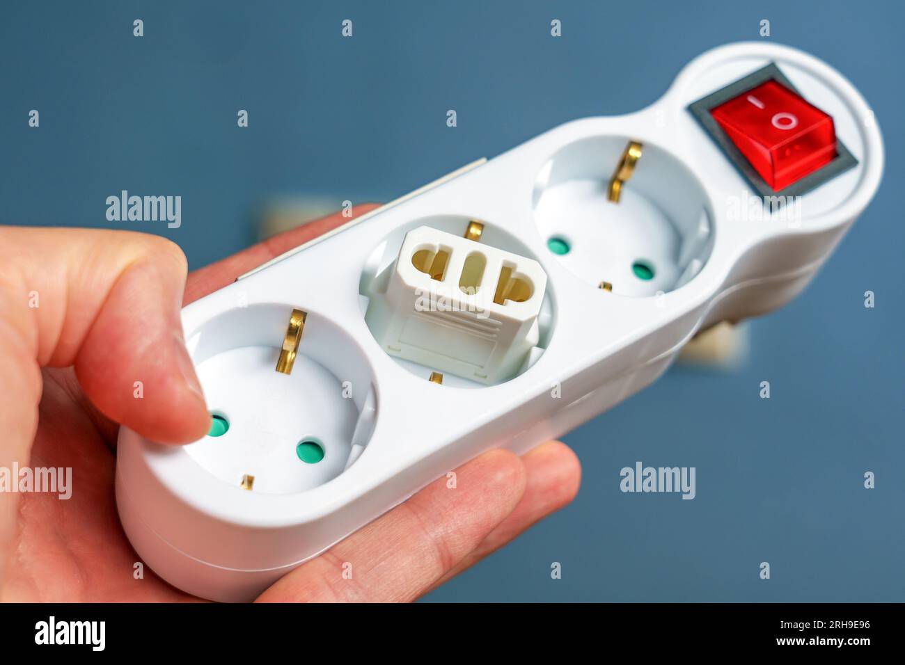 Electrical plug adapter in a European splitter socket in a hotel room close up in room Stock