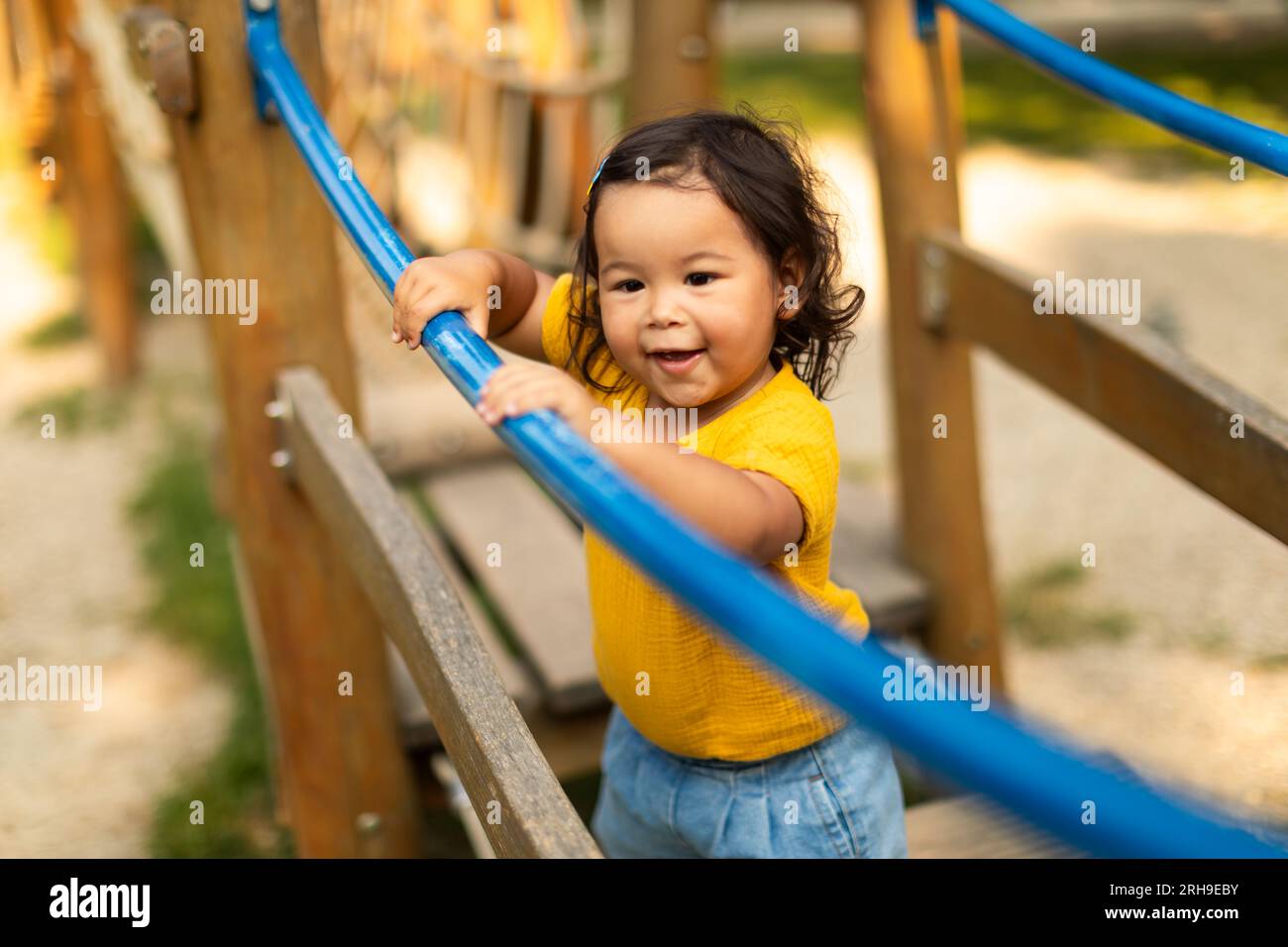 Adorable Asian Toddler Baby Girl Playing Alone On Playground Outside