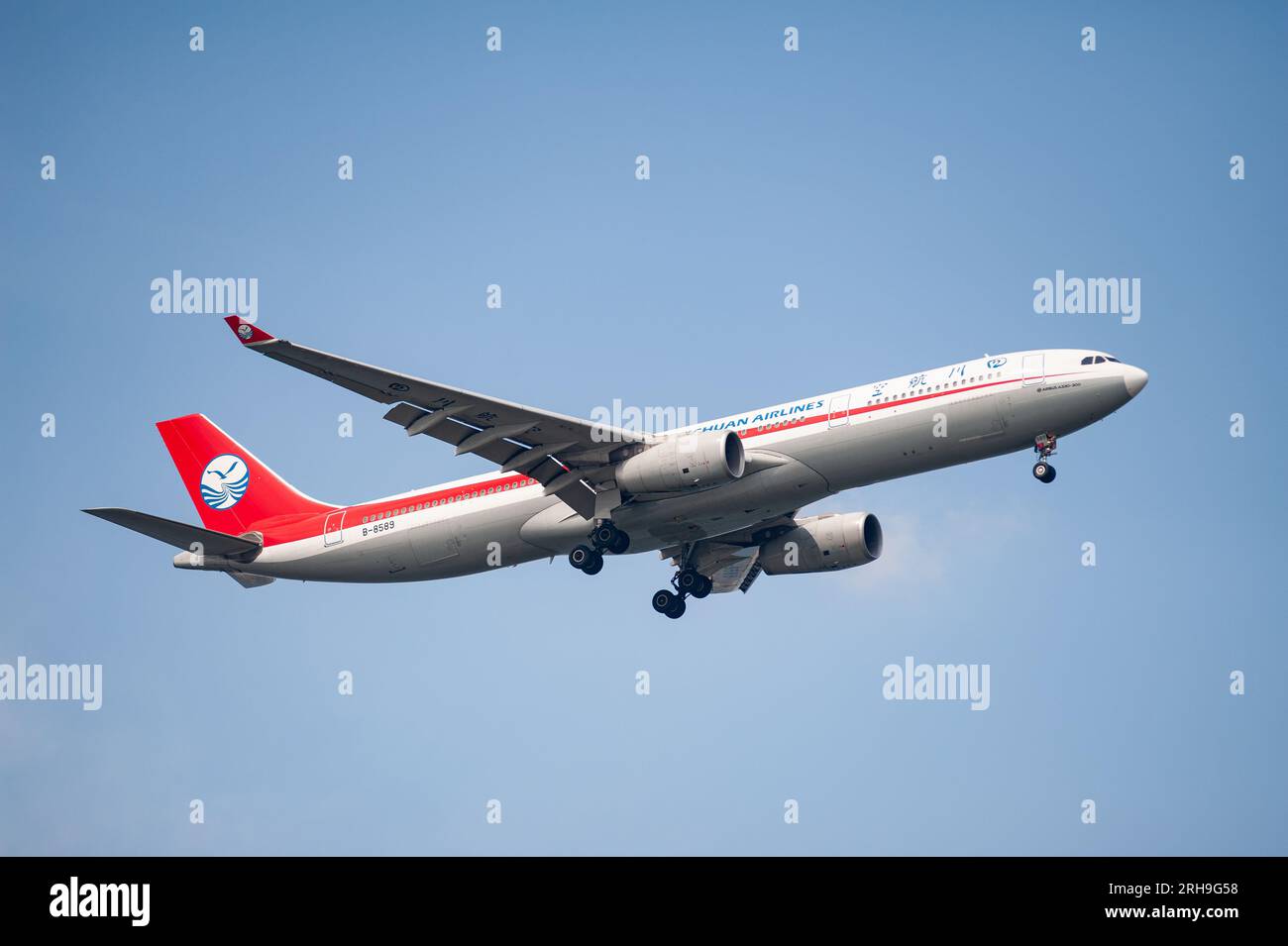 26.07.2023, Singapore, Republic of Singapore, Asia - A Sichuan Airlines Airbus A330-300 passenger aircraft approaches Changi Airport for landing. Stock Photo