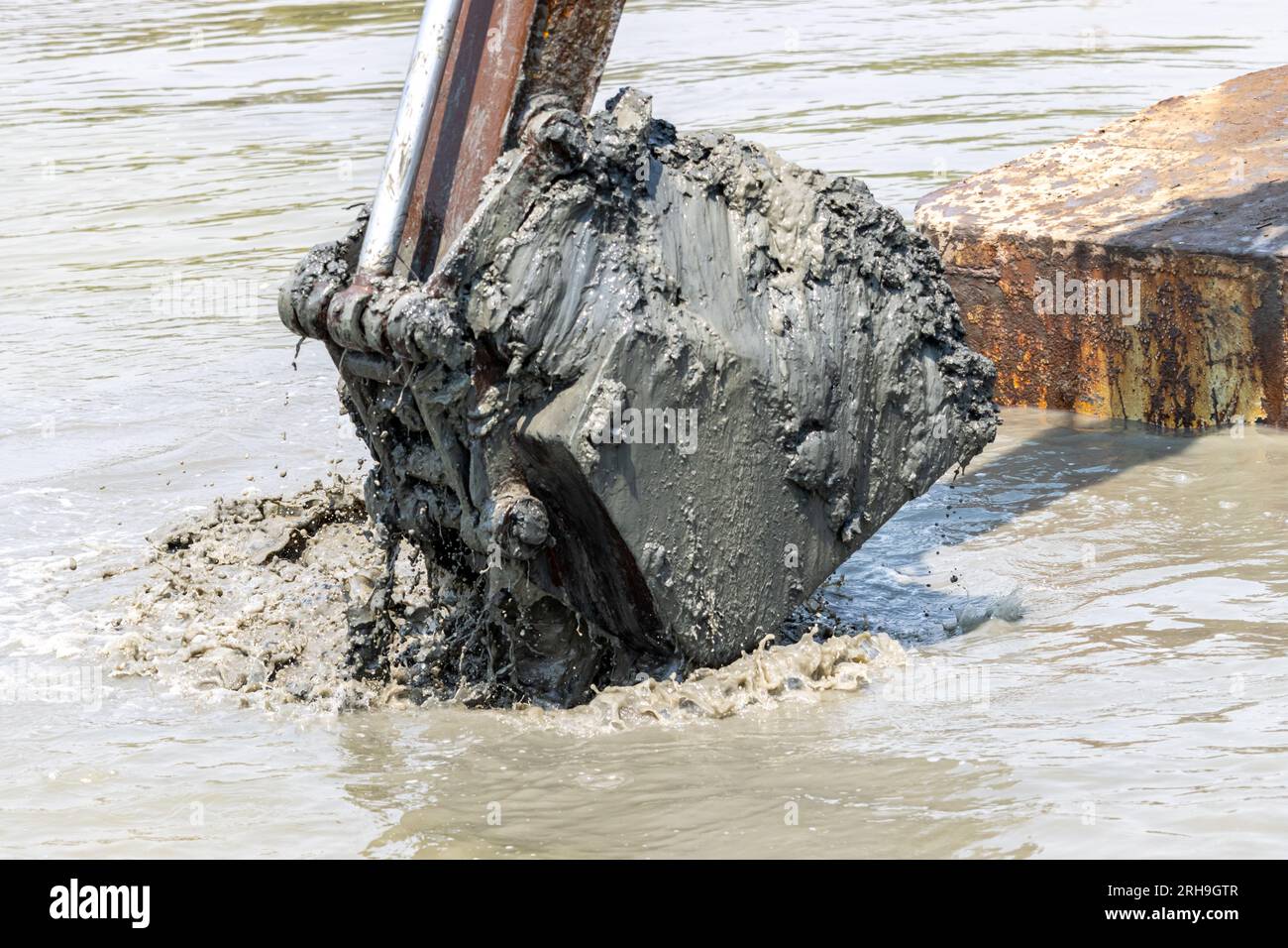 Dredging the bottom of water area, view of the bucket of the floating