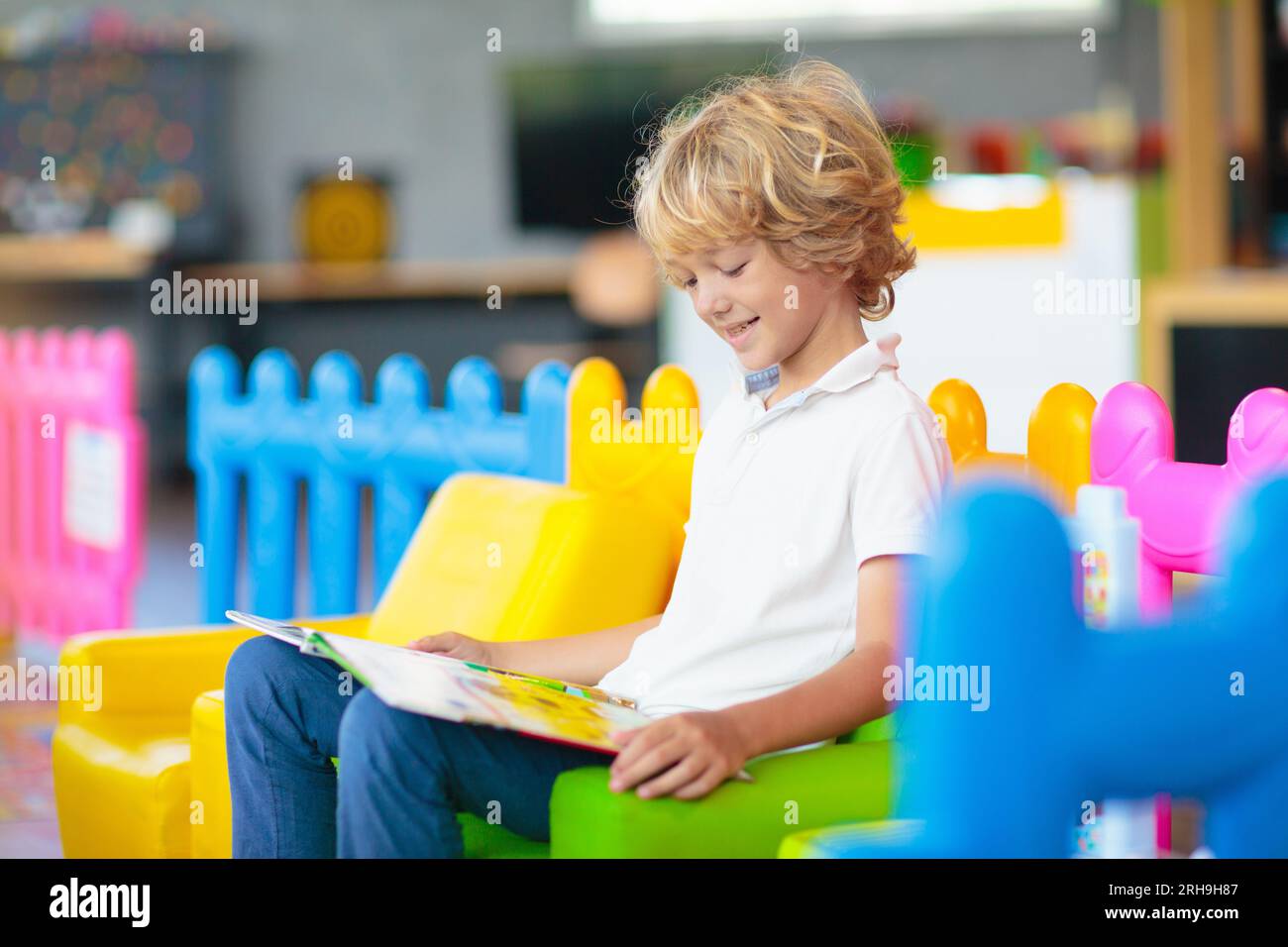 Little boy in kindergarten or daycare. Child playing with colorful