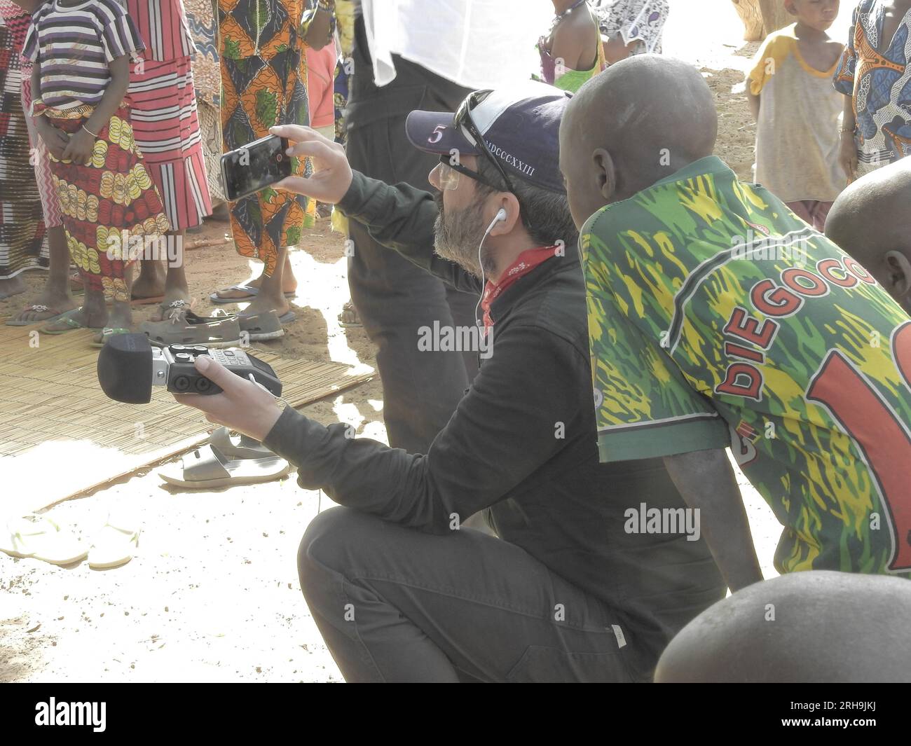 beautiful and meaningful picture of a poor African child looking at a photographer. poor African kid curiously looking at a photographer Stock Photo