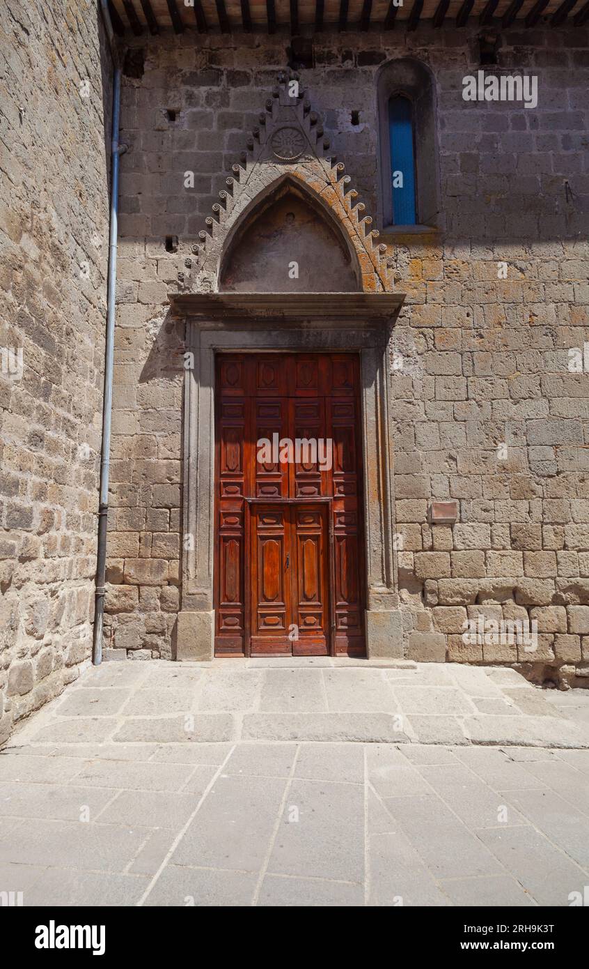 Vertical composition featuring ancient wooden door of Santa Maria Assunta in Cielo church, Vitorchiano. Stock Photo