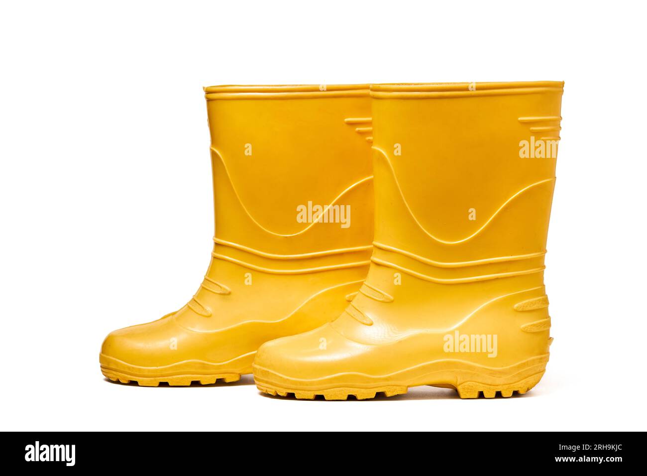 Pair of yellow rubber boots for kids isolated on white background side ...