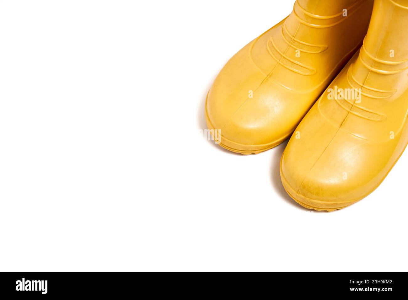 Pair of yellow rubber boots for kids isolated on white background three ...