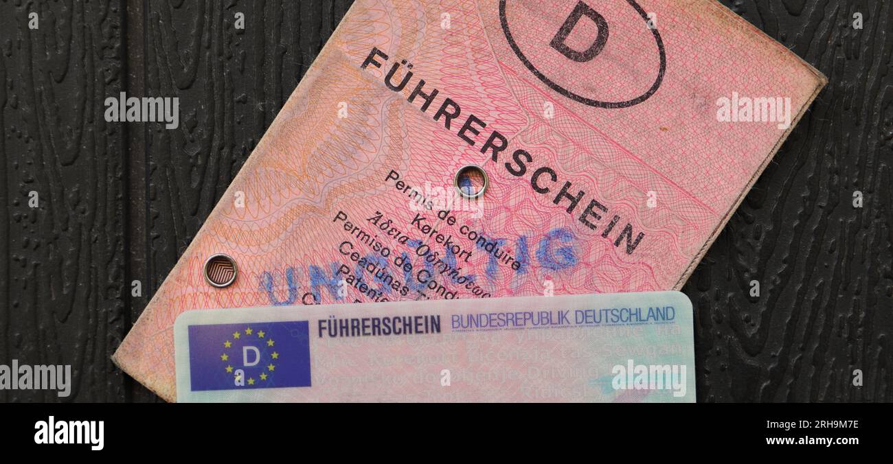 an old and new German driving license with the inscription 'Führerschein' and a car key Stock Photo