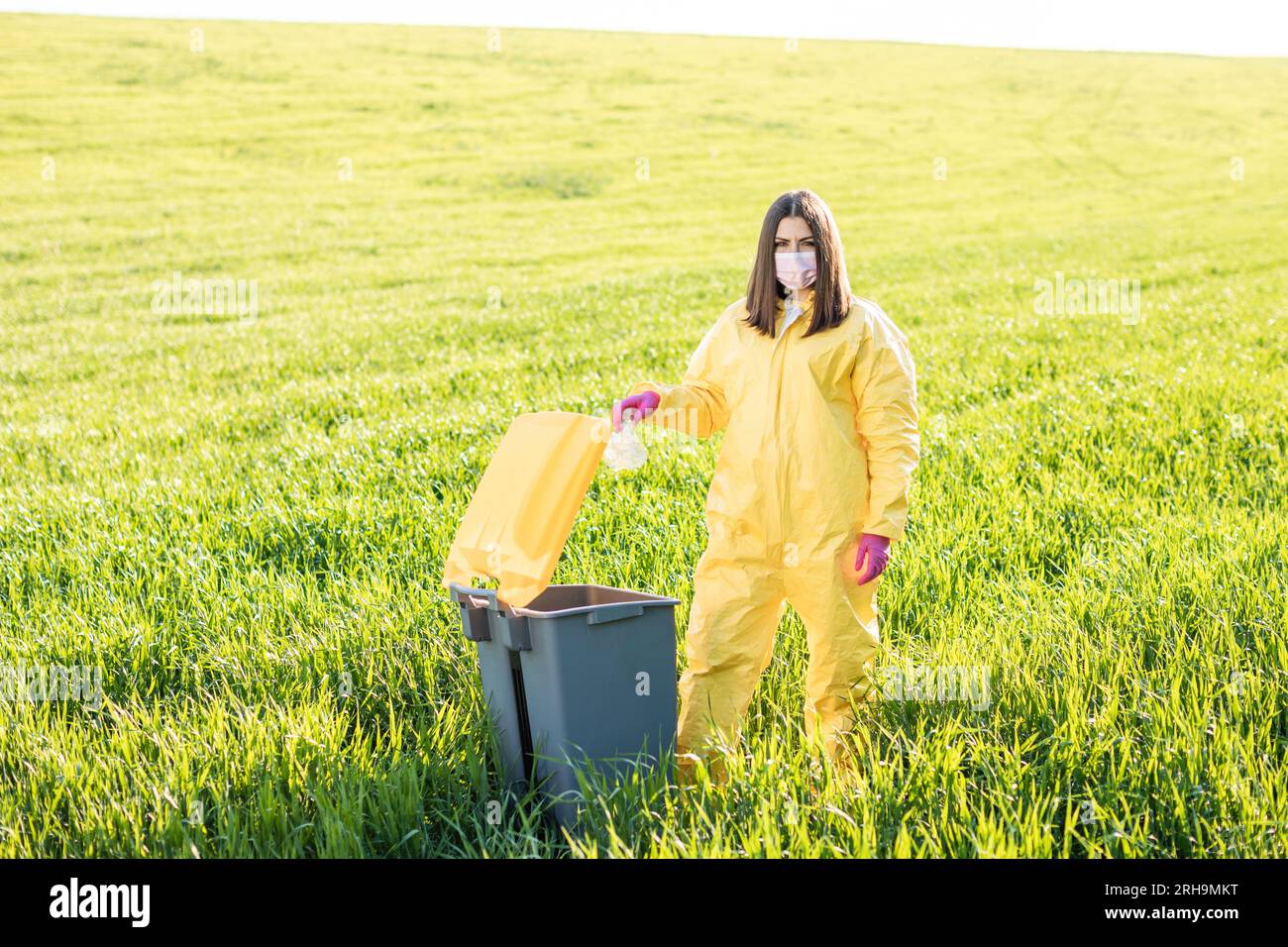 Hand throwing away plastic bottle in nature. Environmental damage by
