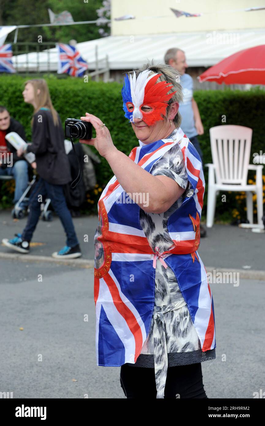 Woman draped in Union Jack Flag at Royal Wedding Street party in Upper Road, Madeley, Telford. Stock Photo