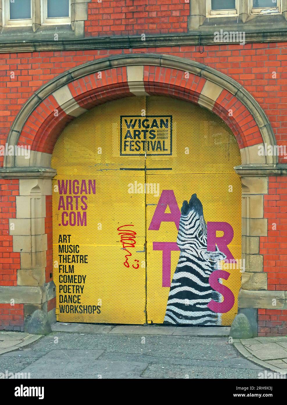 Yellow door at Wigan Arts Festival - WiganArts at the old court building Stock Photo