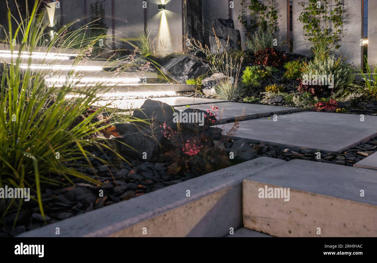 Rockery Garden with LED Lighting Installed Under Concrete Stairs. Small Architecture Theme. Stock Photo