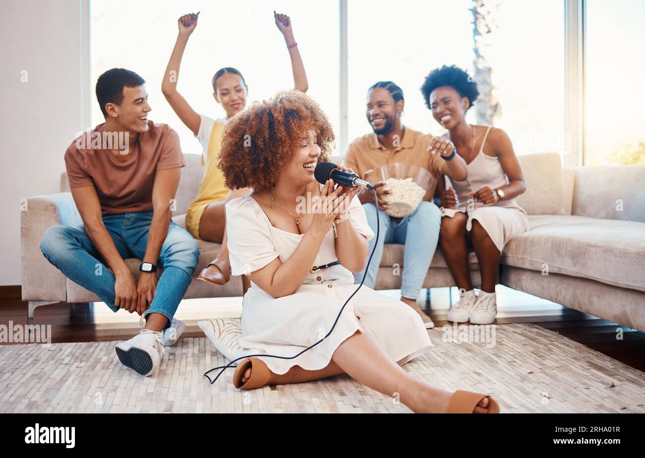 Microphone, happy people or woman singing in home living room together in party on holiday vacation break. Girl singer, men or group of funny women Stock Photo