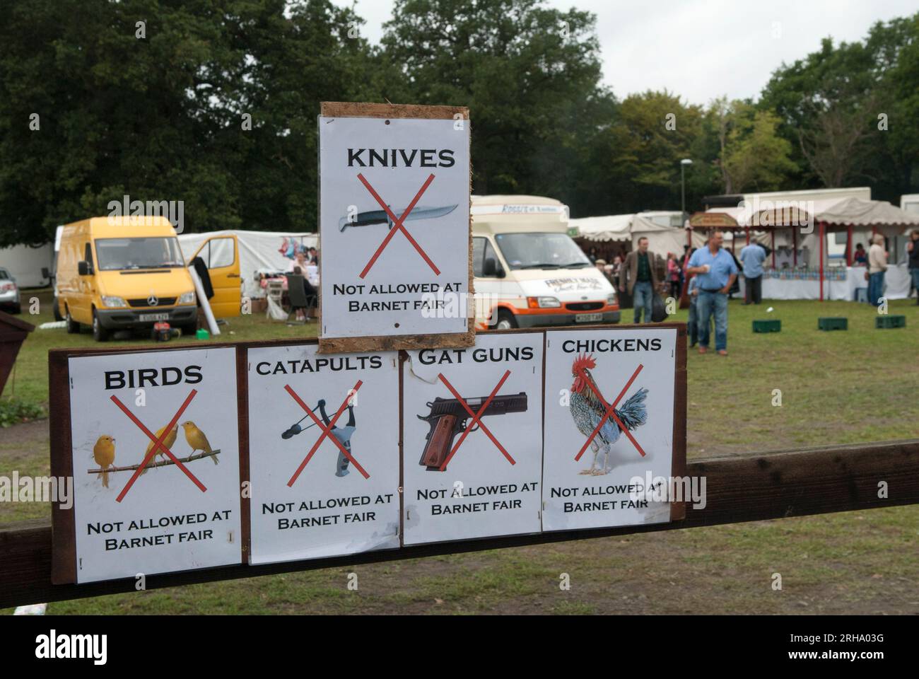 Barnet Gypsy Horse Fair Hertfordshire UK. Warning sign No Knives, No Gat Guns, No Chickens, No Birds, No Catapults signs 2010s 2011 In 1588 Queen Elizabeth I granted Bartnet a Royal charter to hold a Fair. HOMER SYKES Stock Photo