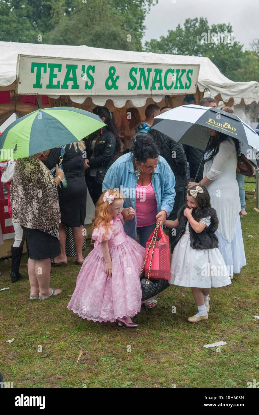 Gypsy children girls dressed in best cloths with grandmother.  Barnet Gypsy Horse Fair Hertfordshire UK. 2010s 2011 HOMER SYKES Stock Photo