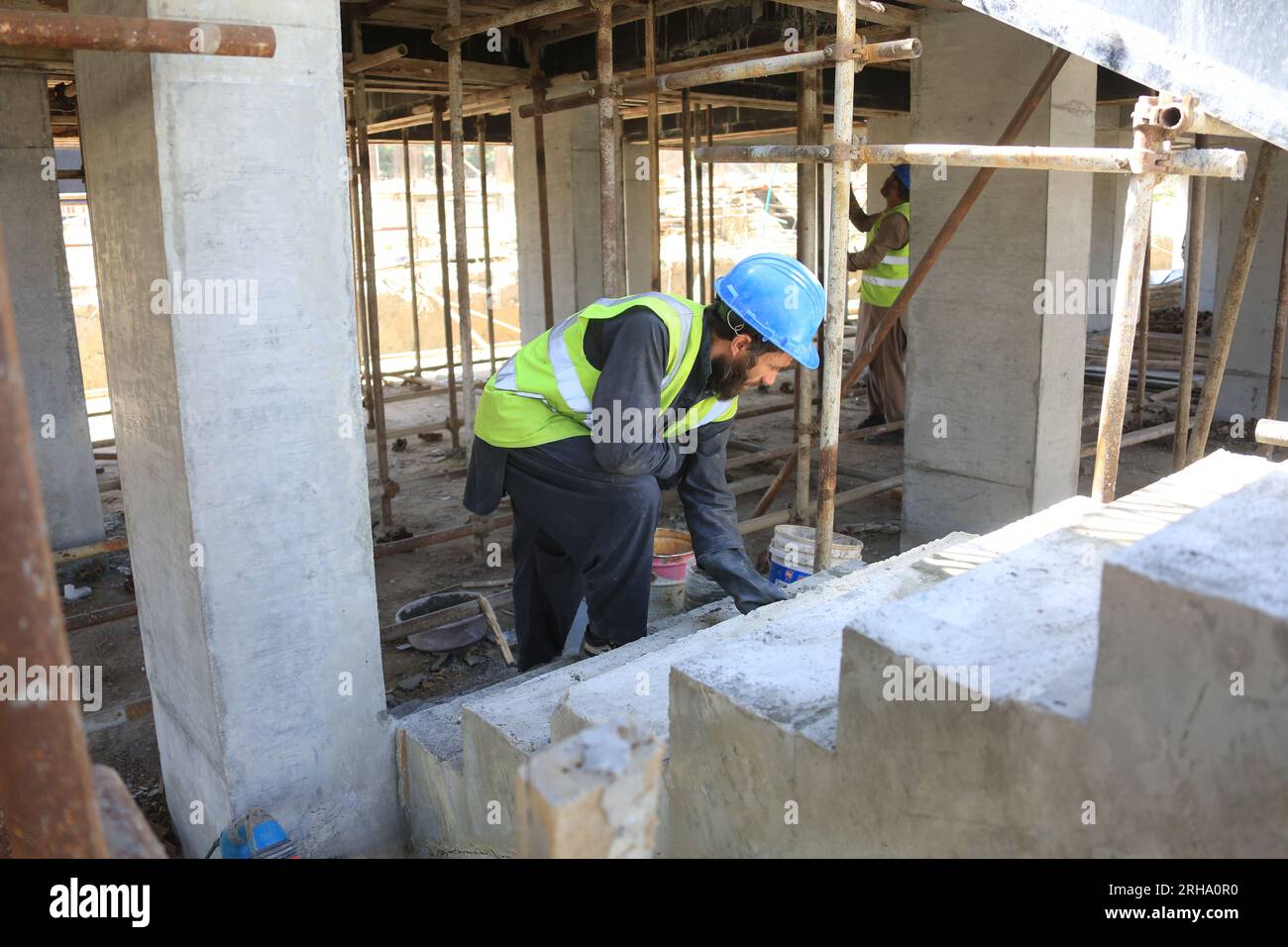 Kabul, Afghanistan. 13th Aug, 2023. An Afghan employee works at the construction site of a China-funded housing complex in Kabul, Afghanistan, Aug. 13, 2023. TO GO WITH 'Feature: Afghan staffer makes big stride in China-invested project' Credit: Saifurahman Safi/Xinhua/Alamy Live News Stock Photo