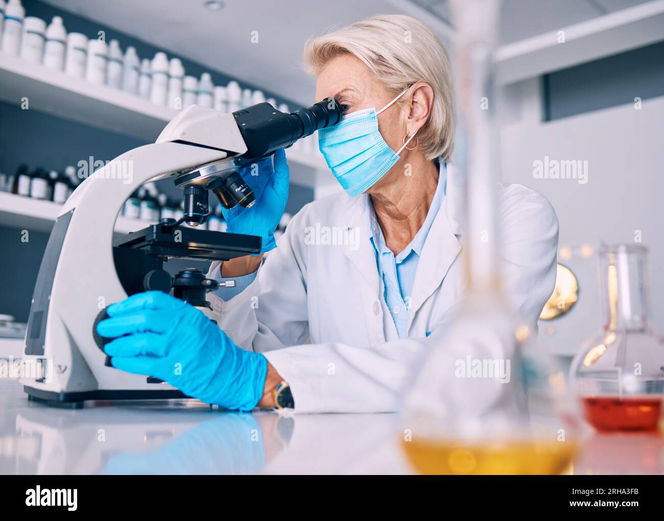 Science woman, microscope analysis and covid in lab, medical research or pharma job for