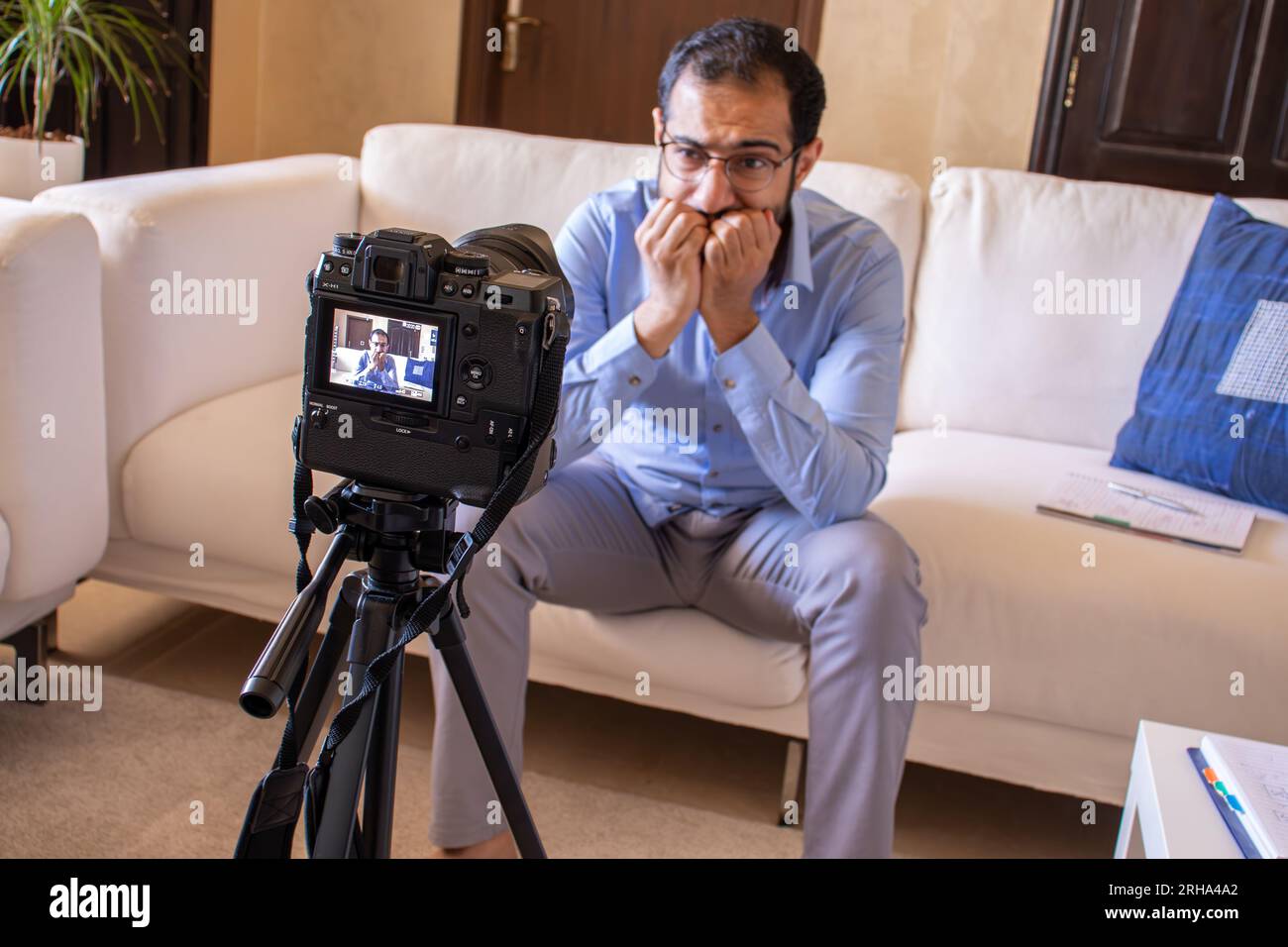 Young arabic businessman streaming from home Stock Photo