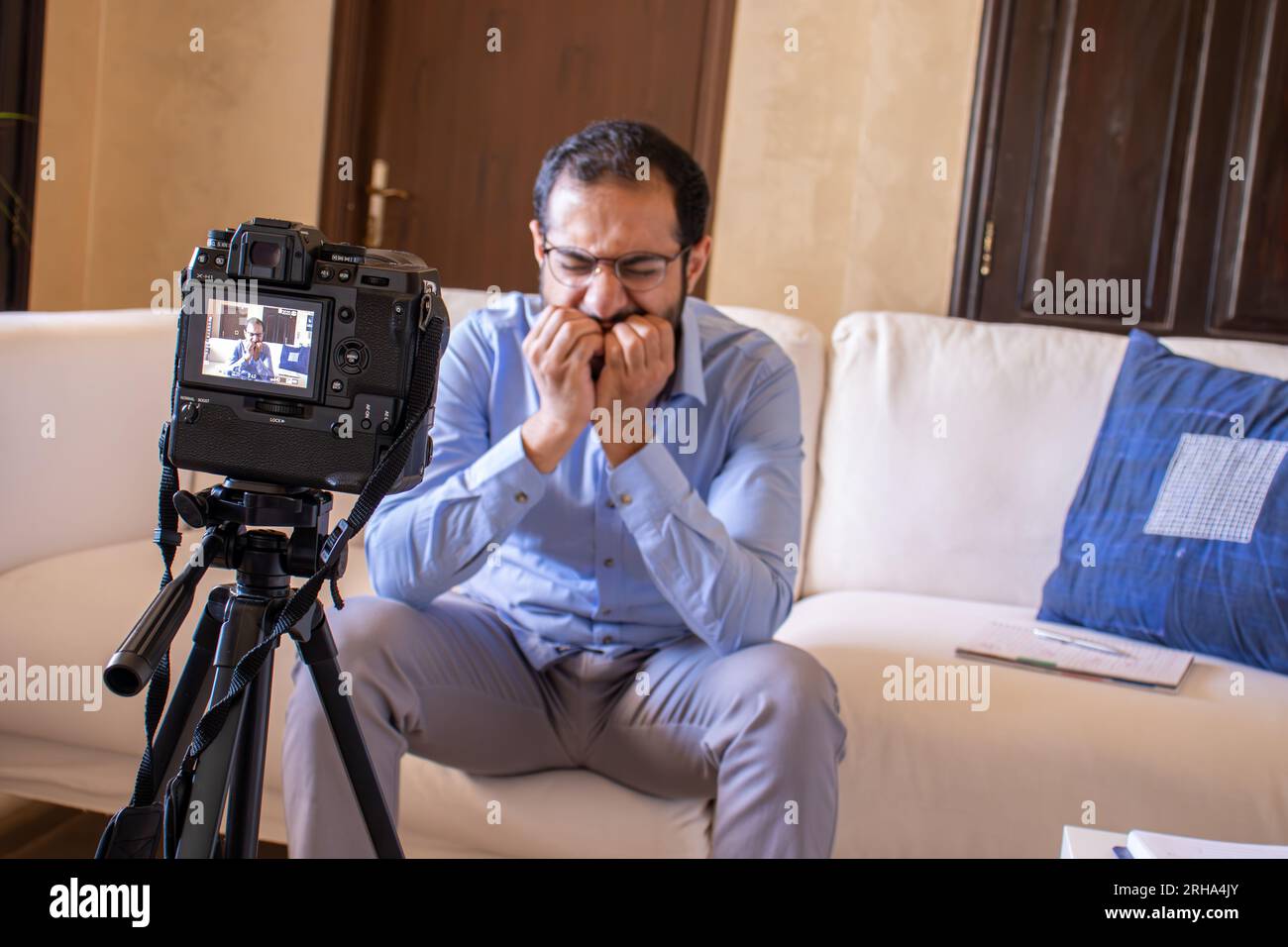 Young arabic businessman streaming from home Stock Photo