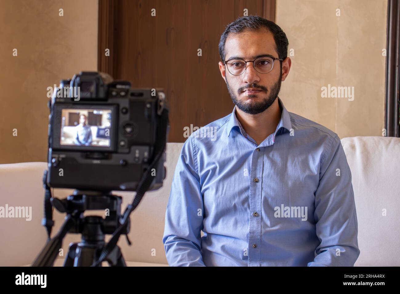 Young arabic businessman streaming from home Stock Photo