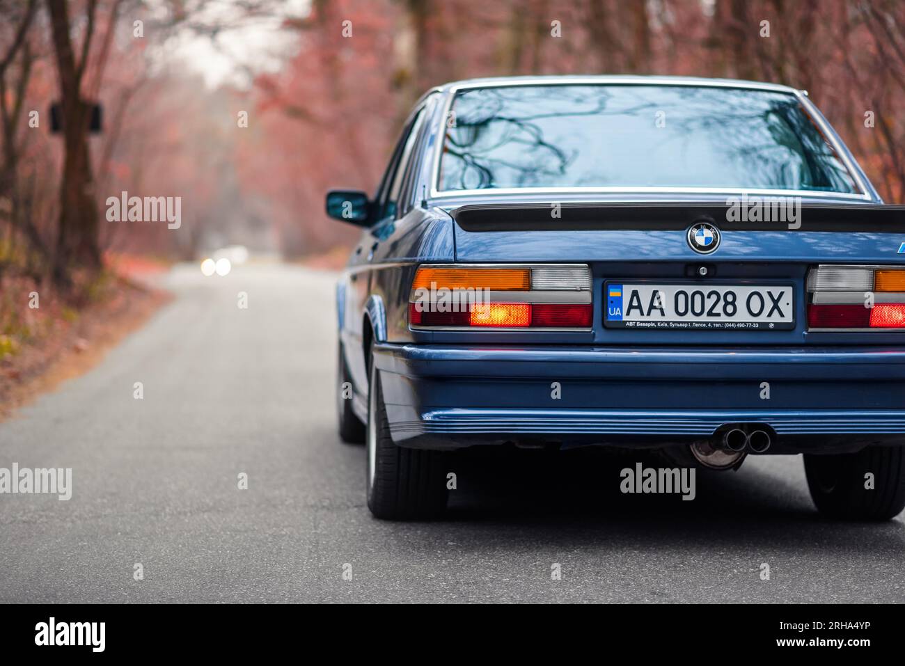 dark blue BMW 5-series E28 standing still in autumn forest. Weekend ...