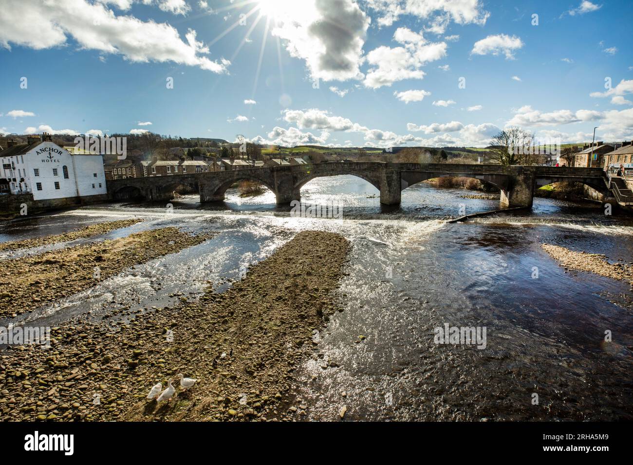 Sunshine over the old bridge over the River South Tyne at Haydon Bridge, Northumberland Stock Photo