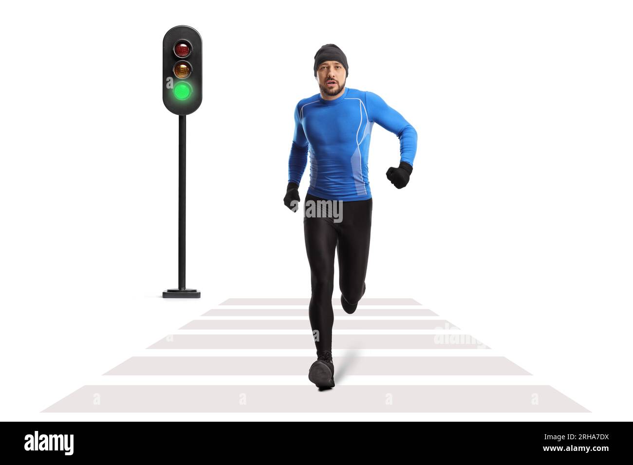 Full length portrait of a fit man in winter running clothes jogging at