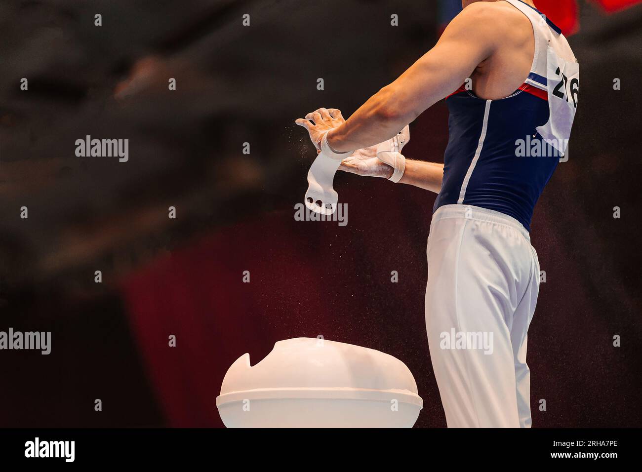 gymnast apply gym chalk in hands from magnesia stands, preparation for