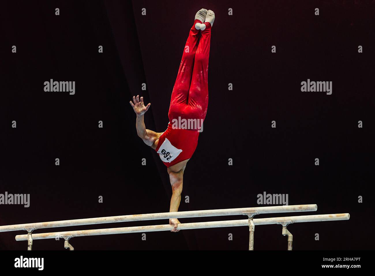gymnast exercise parallel bars in championship gymnastics, element onearm stand Stock Photo Alamy