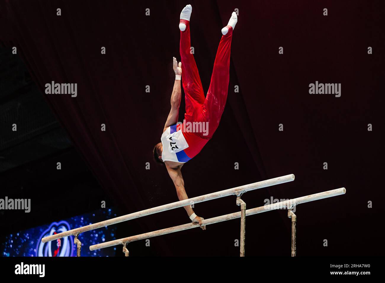 gymnast exercise parallel bars in championship gymnastics Stock Photo