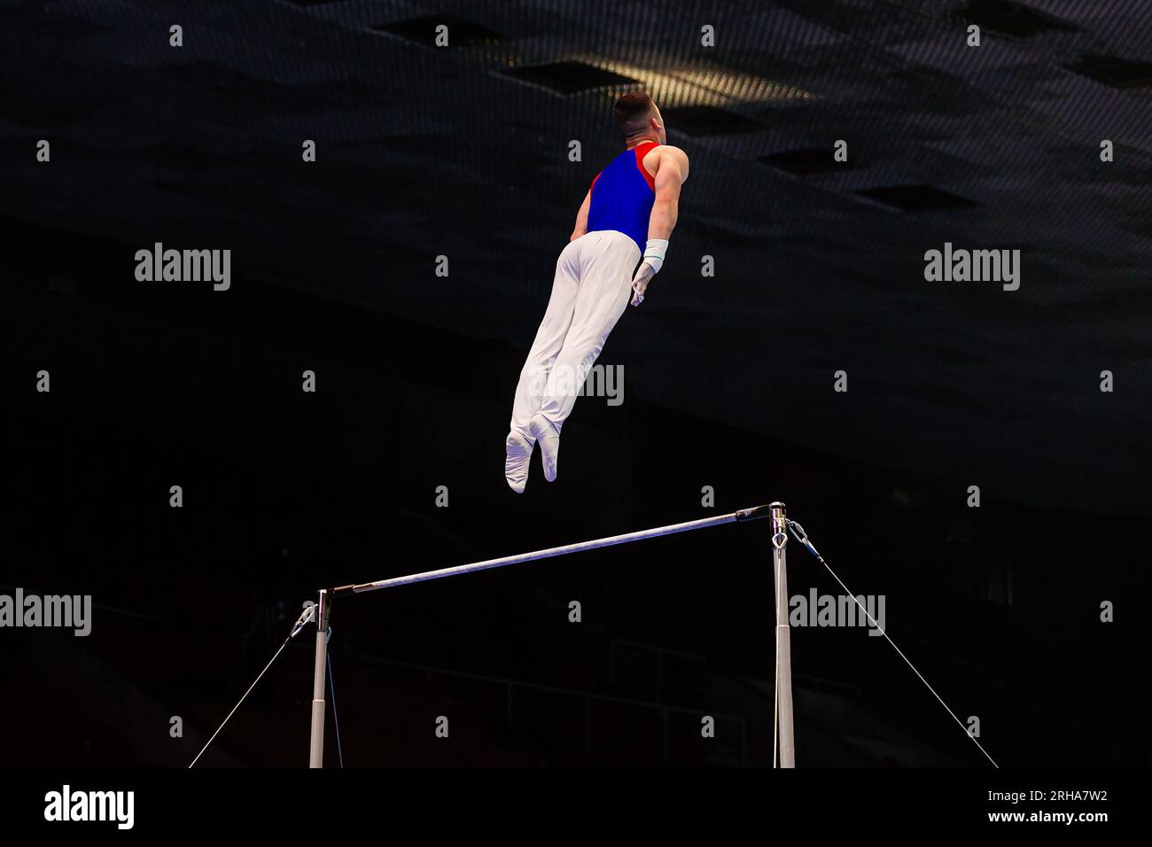 gymnast exercise horizontal bar in championship gymnastics, flying man