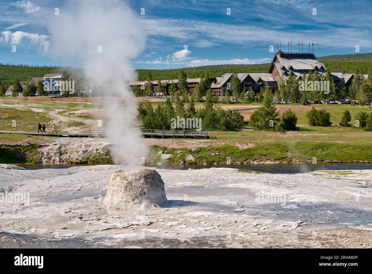 Beehive Geyser and Old Faithful Inn, Upper Geyser Basin, Yellowstone National Park, Wyoming, United States of America Stock Photo
