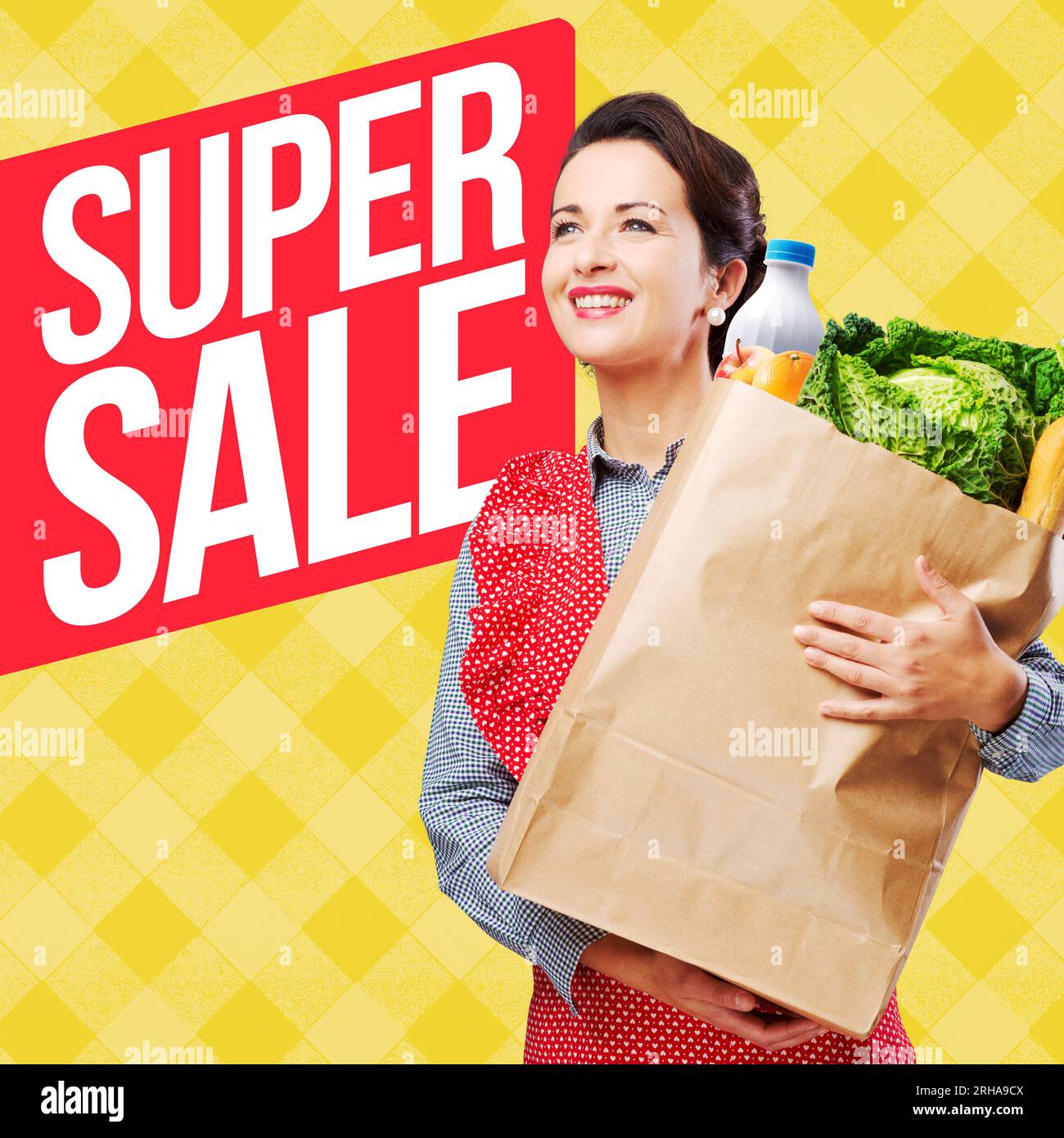 Smiling vintage woman in apron holding a shopping grocery bag. Stock Photo