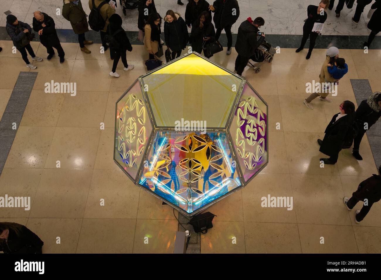 People inspecting Seed of Life art installation Canary Wharf Winter