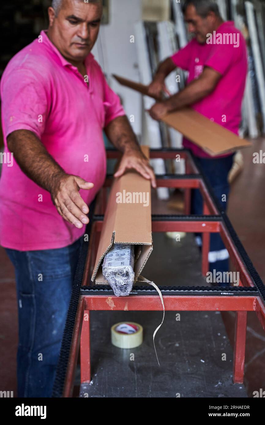 Workers packing cardboard box in warehouse for shipment. an operator ...
