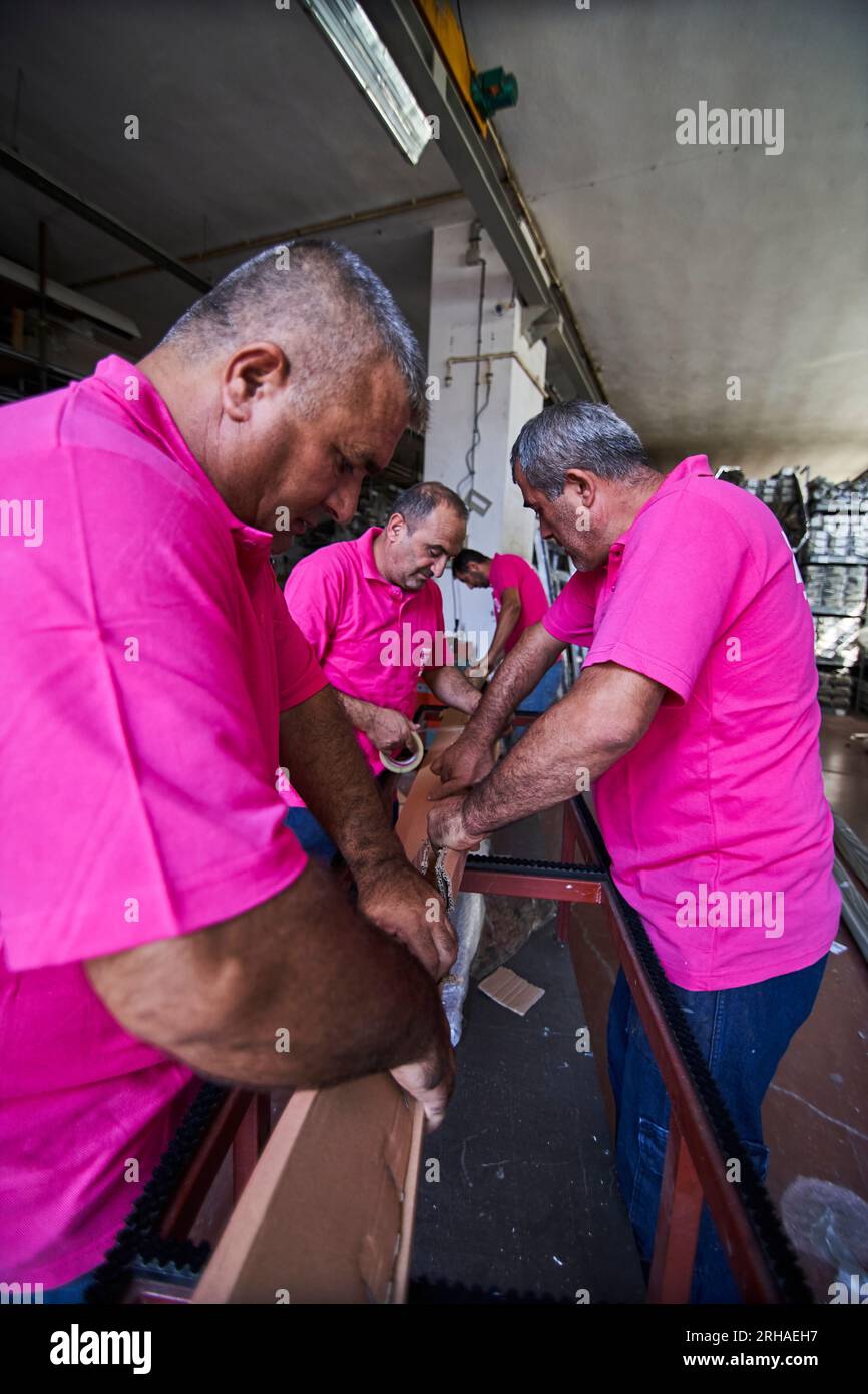 Workers packing cardboard box in warehouse for shipment. an operator ...