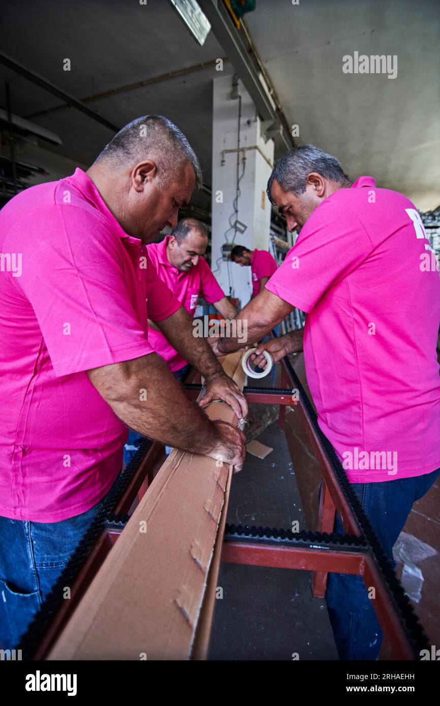 Workers packing cardboard box in warehouse for shipment. an operator ...