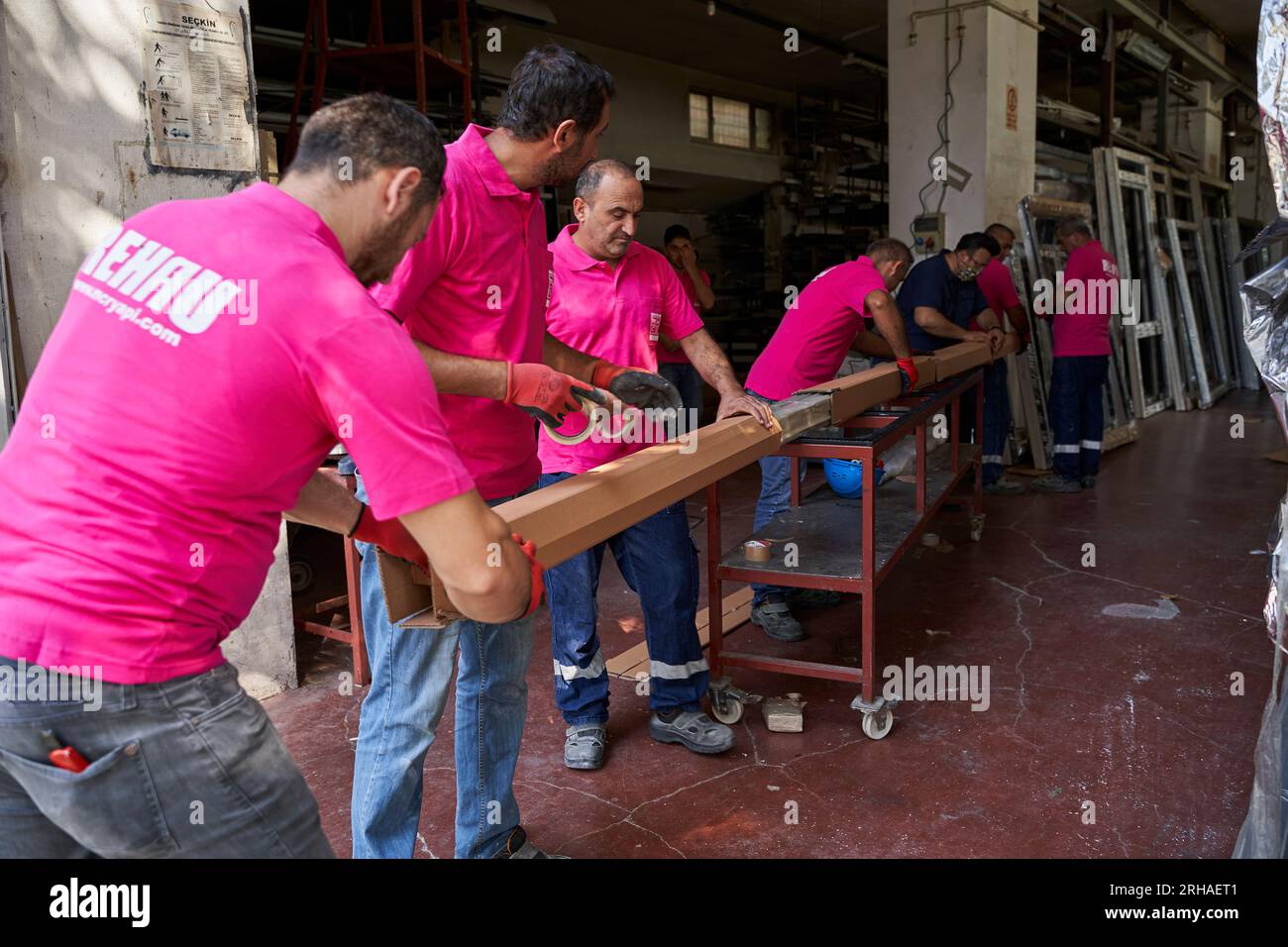 Workers packing cardboard box in warehouse for shipment. an operator ...